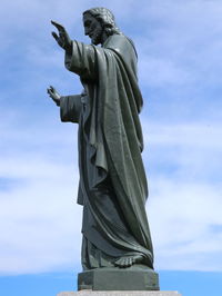 Low angle view of statue against cloudy sky