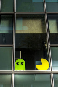 Low angle view of yellow window on building