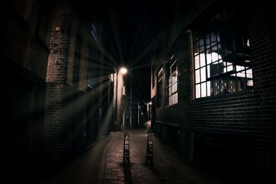 Street amidst buildings in city at night