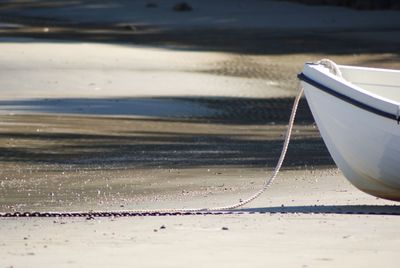 Close-up of boat moored on beach