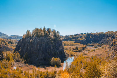 Scenic view of mountains against clear blue sky