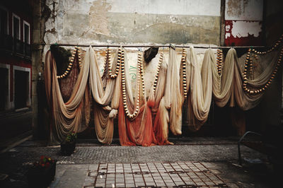 Clothes hanging on footpath by street in city