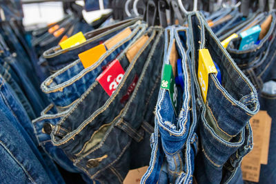 Close-up of jeans hanging for sale at store