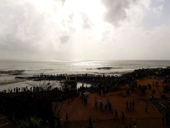 People on beach against sky