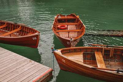 Boats moored at pier on lake