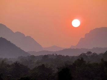 Scenic view of silhouette mountains against sky during sunset