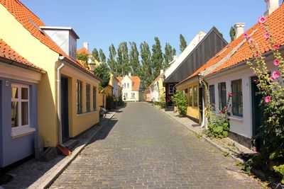 Street amidst buildings against sky