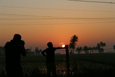 Silhouette of people at sunset