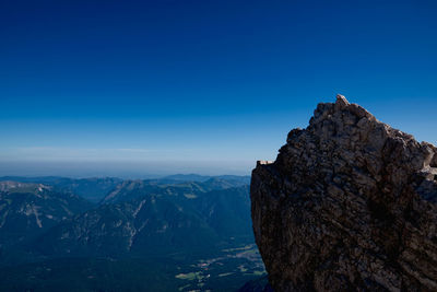 Scenic view of mountain against blue sky