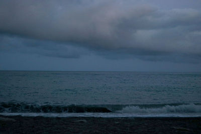 Scenic view of sea against storm clouds