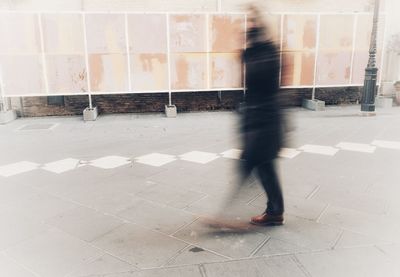 Low section of man walking on floor