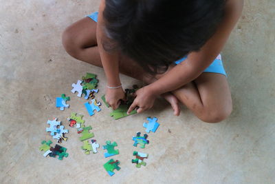 High angle view of child playing on floor