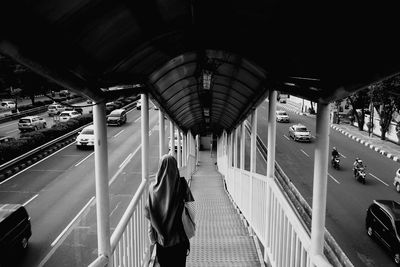 Rear view of people walking on railroad station platform