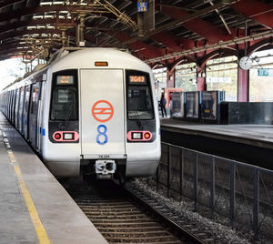 Delhi metro train arriving at jhandewalan metro station in new delhi, india, public metro departing