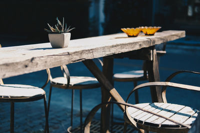 Chairs and tables on table by sea