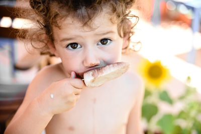 Close-up portrait of boy eating food