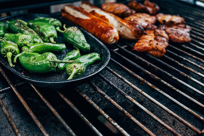 Close up of pimientos de padron on barbecue grill