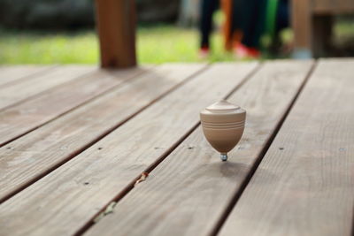 Close-up of spinning top on floorboard