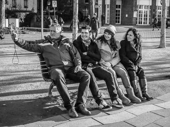 People sitting on bench in city