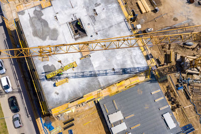 Crane and highrise construction site. aerial view