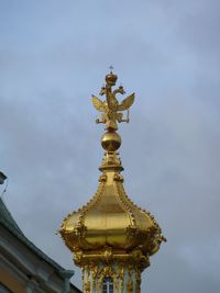 Low angle view of sculpture against building