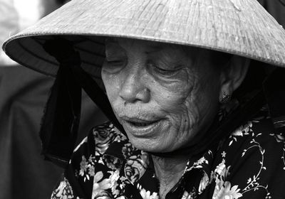 Close-up of senior woman wearing hat looking down