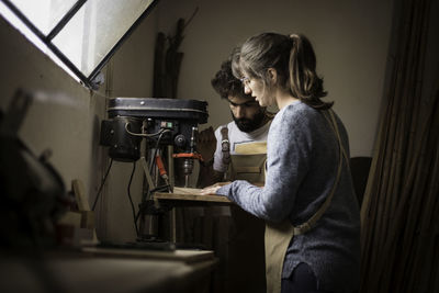 Side view of man working on laptop