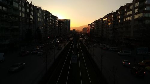 High angle view of street amidst buildings against sky during sunset