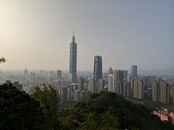 Modern buildings in city against clear sky