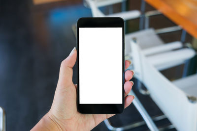 Close-up of hand holding mobile phone