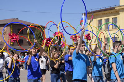 Group of people against multi colored umbrellas