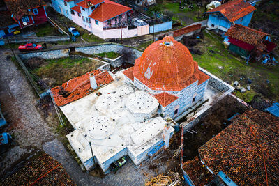 High angle view of wet walkway amidst buildings in city