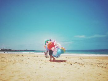 Full length of woman on beach against sky