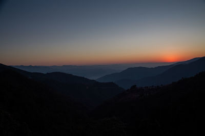 Scenic view of silhouette mountains against sky during sunset