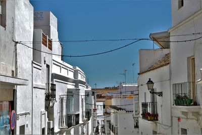 View of residential buildings against blue sky