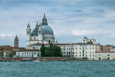 View of basilica di santa maria della salute by the grand canal waterfront  against sky