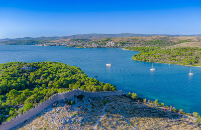 High angle view of townscape by sea against sky