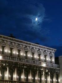 Illuminated built structure against blue sky