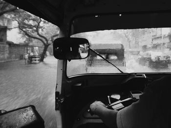 Cropped hand driving jinrikisha during rainfall