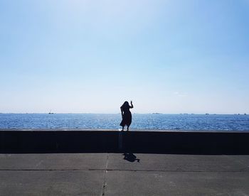 Man on sea against clear sky