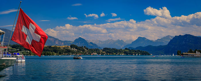 Scenic view of sea and mountains against sky