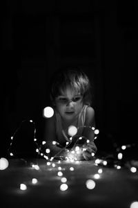 Portrait of girl playing in the dark