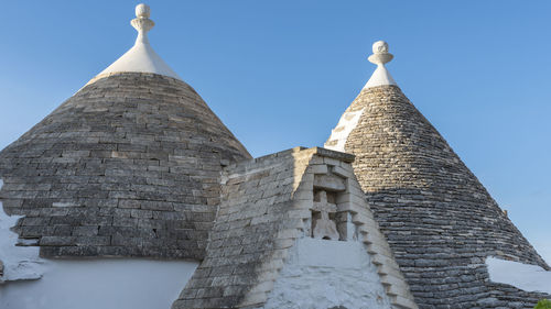 Trulli of the itria valley. farmhouses. details in the sky. puglia, italy.