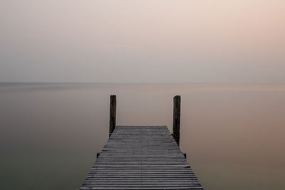 Pier over sea against sky