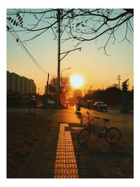 Cars on road at sunset