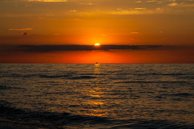 Scenic view of sea against romantic sky at sunset