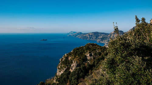 Scenic view of sea against clear blue sky