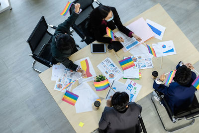 High angle view of people sitting on table