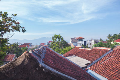 High angle view of houses and buildings against sky