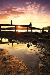 Scenic view of beach against sky during sunset